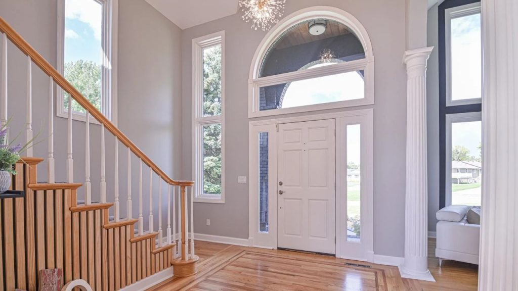 Bright entryway with tall windows and wood floors.