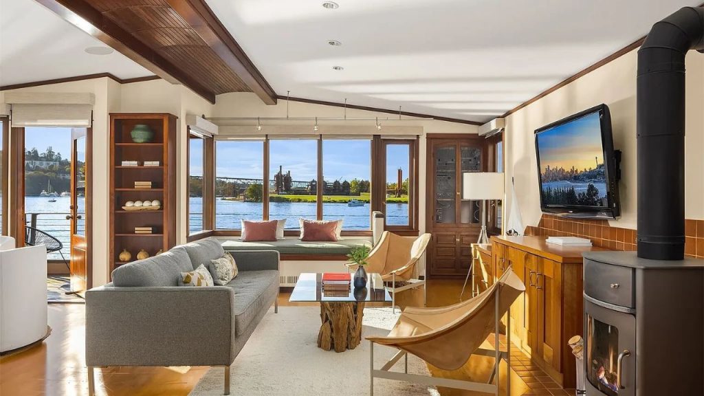 Cozy living room with waterfront views, wood accents, and modern furniture.