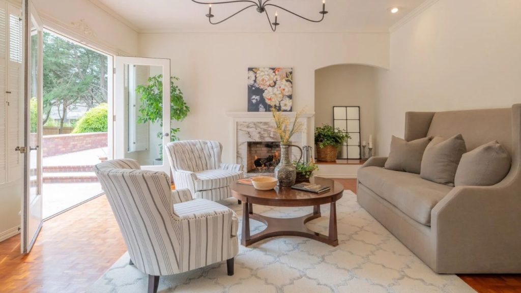 A warm and inviting living room with open doors to a garden view.