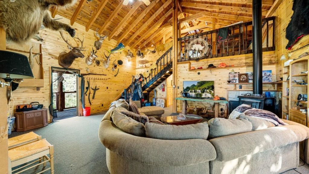 Cozy lodge-style living room with vaulted ceilings and rustic decor.