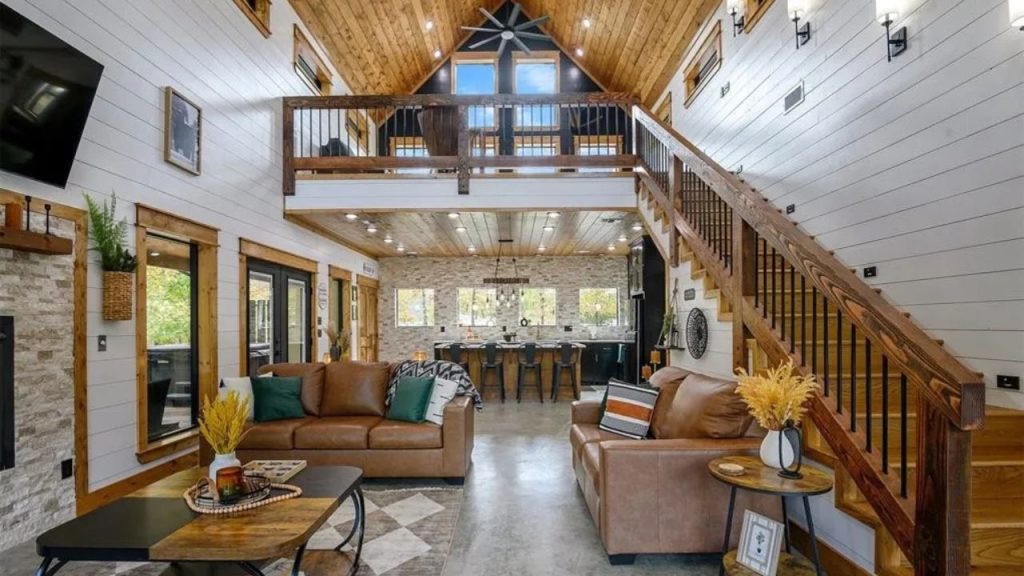 Open living room with staircase and kitchen in view