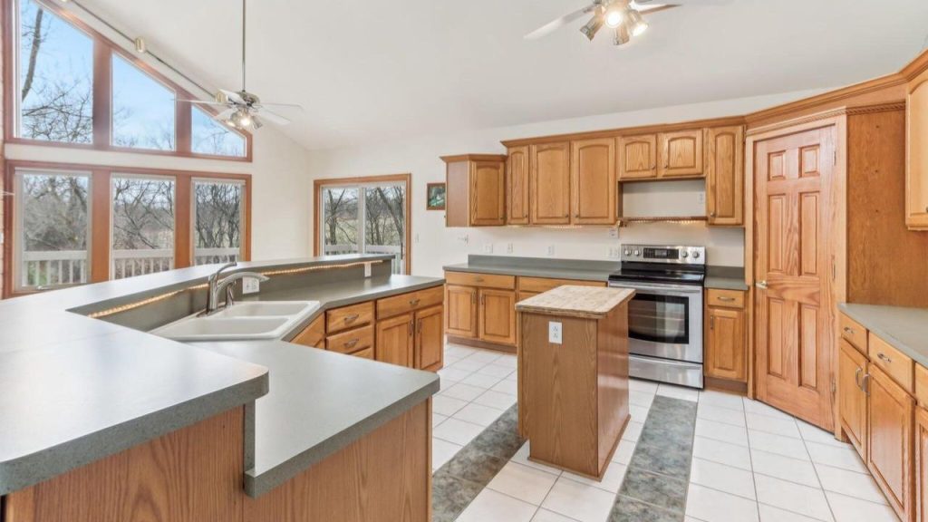 Warm wood kitchen with large windows and center island.