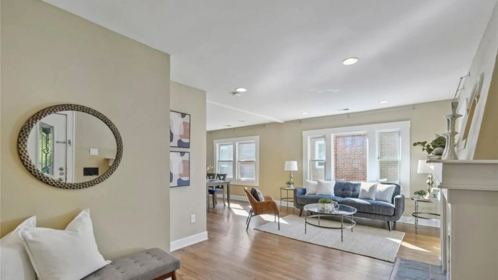 Bright living room with wood floors and large windows.