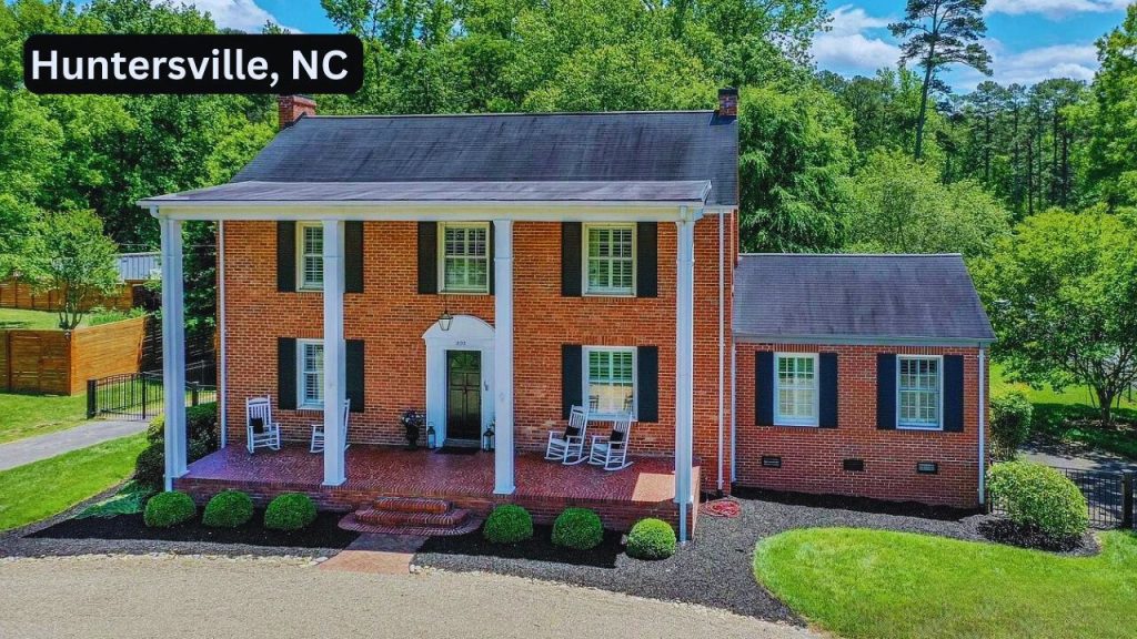 Colonial-style brick home with white columns and a front porch in Huntersville, NC.