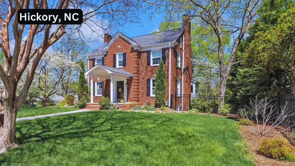 Red-brick Colonial home with black shutters and a gabled porch in Hickory, NC.