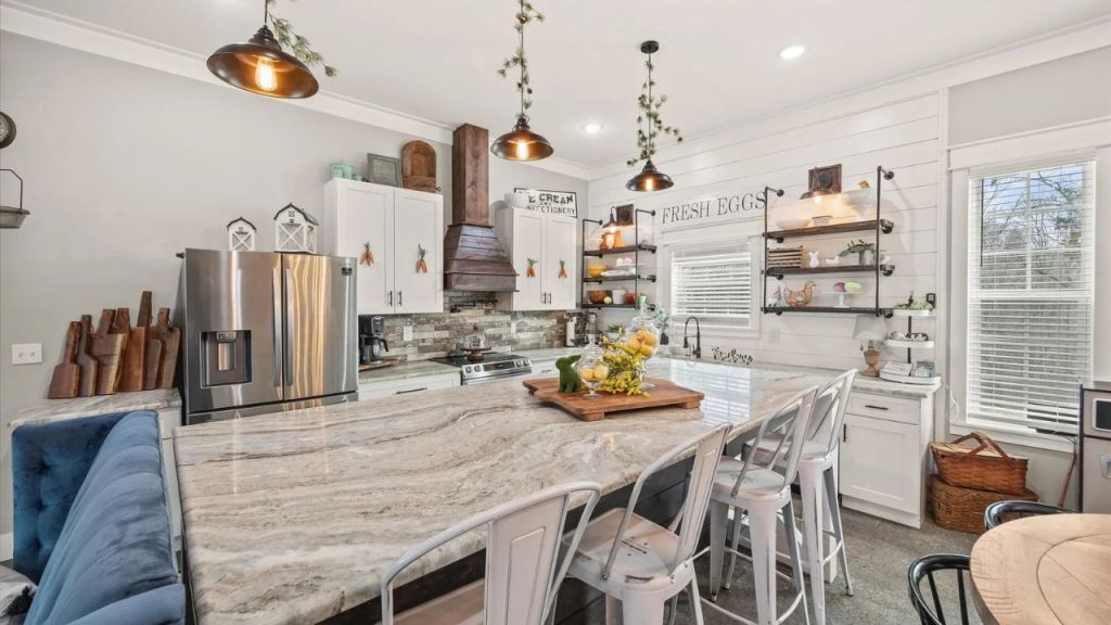 Bright farmhouse kitchen with a large island, rustic decor, and modern appliances.