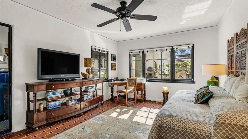 Relaxed lounge-style room with terracotta floors and vintage decor.