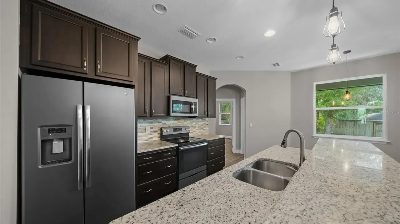 Discover This Bright and Open 3-Bedroom 1,685 Sq-Ft Ranch-Style Home with Granite Counters and Large Pantry in Groveland, FL (Floor Plan Inside)