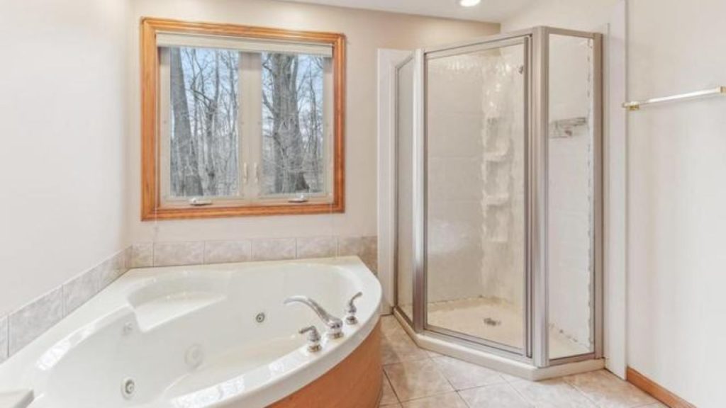 Bathroom with jetted tub and corner shower.