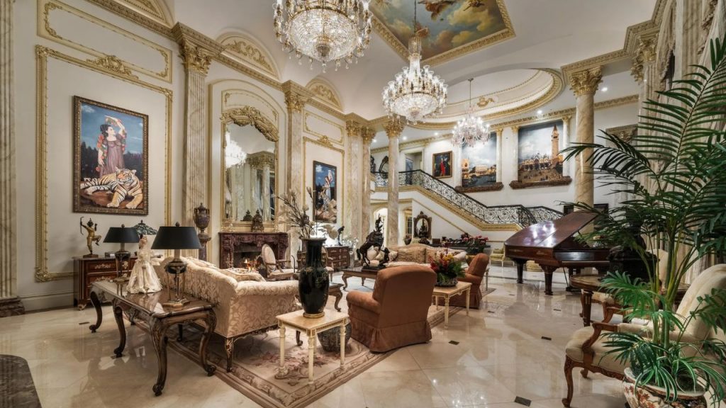 A lavish living room with chandeliers, marble floors, and a grand piano.