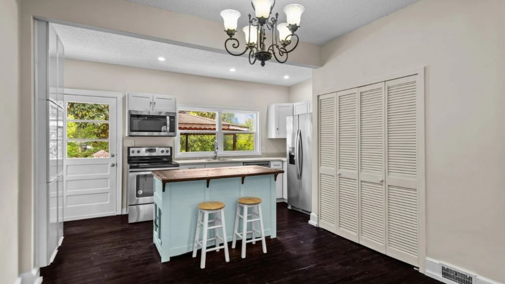 Sunlit Kitchen with Vintage Charm and Backyard Views