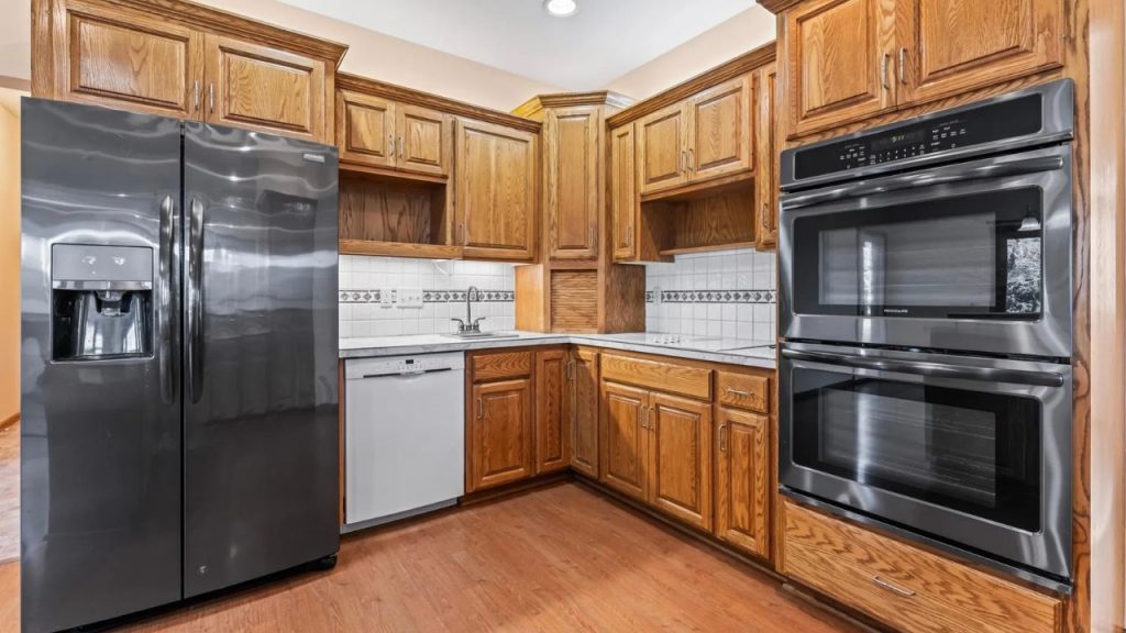Cozy kitchen with oak cabinets and stainless steel appliances.