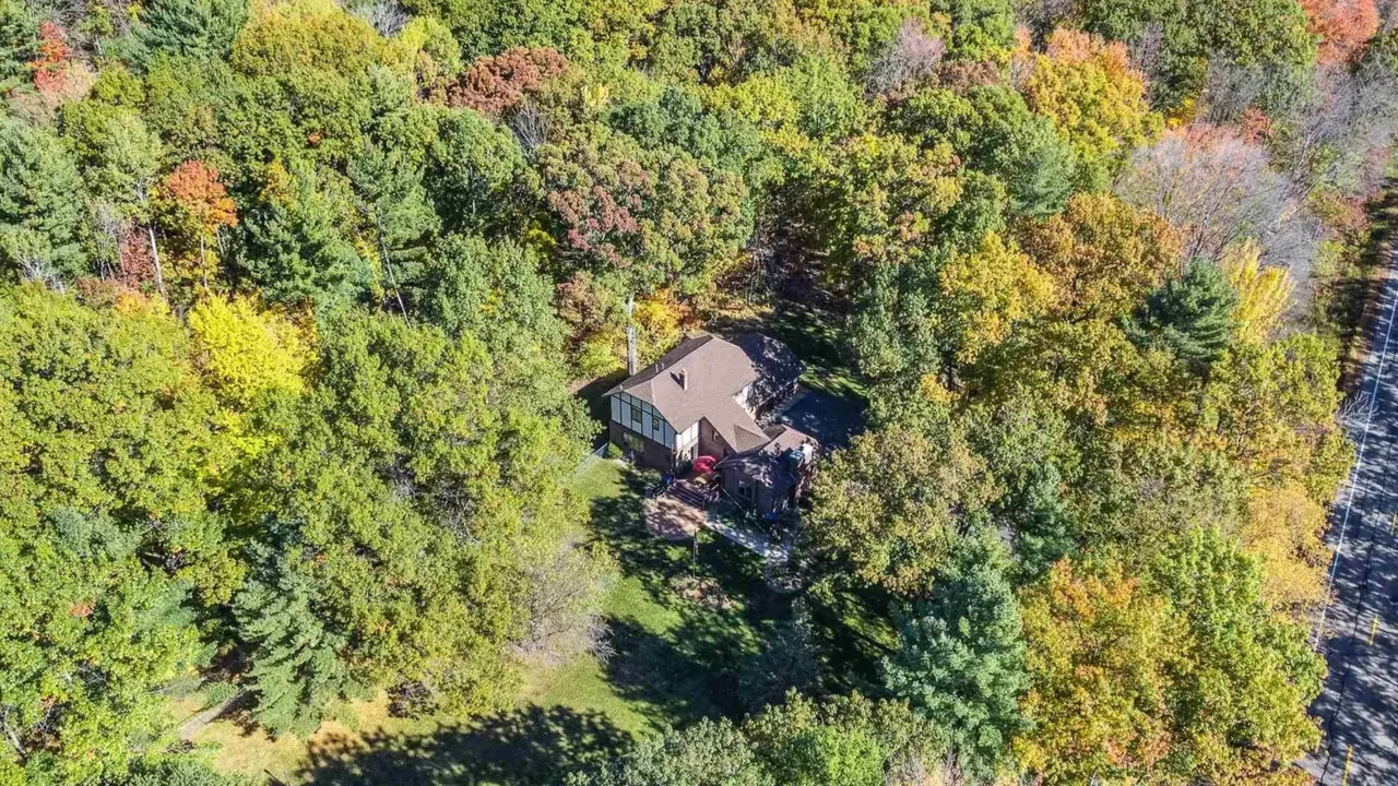 Experience Country Living in This 3-Bedroom Tudor with Garden and Wooded Trails in Stevens Point Wisconsin (Floor Plan Inside)