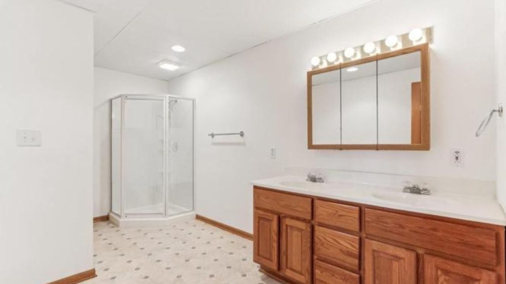 Bathroom with double vanity and corner shower.