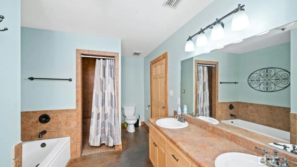 Large bathroom with tub, shower, and double sinks.