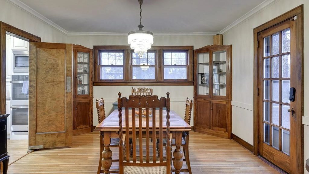Classic dining room with built-ins, wood trim, and a chandelier.