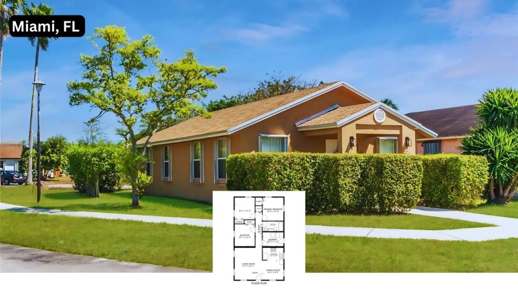 Sunny single-family home with tan exterior and well-kept lawn in Miami.