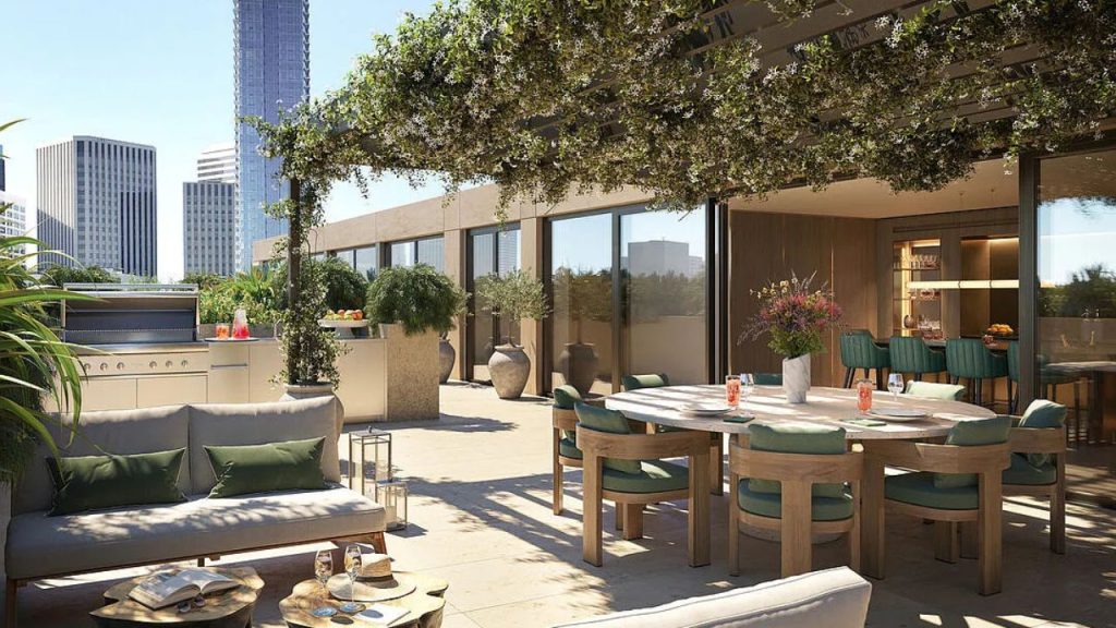Rooftop terrace with greenery, dining area, and city skyline.