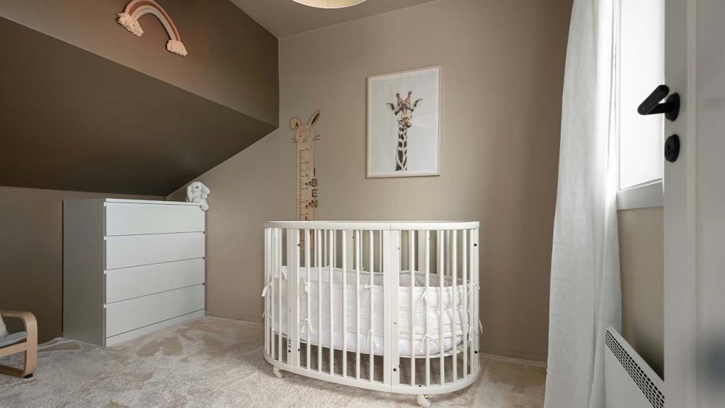 A baby's room with a crib and a rocking chair
