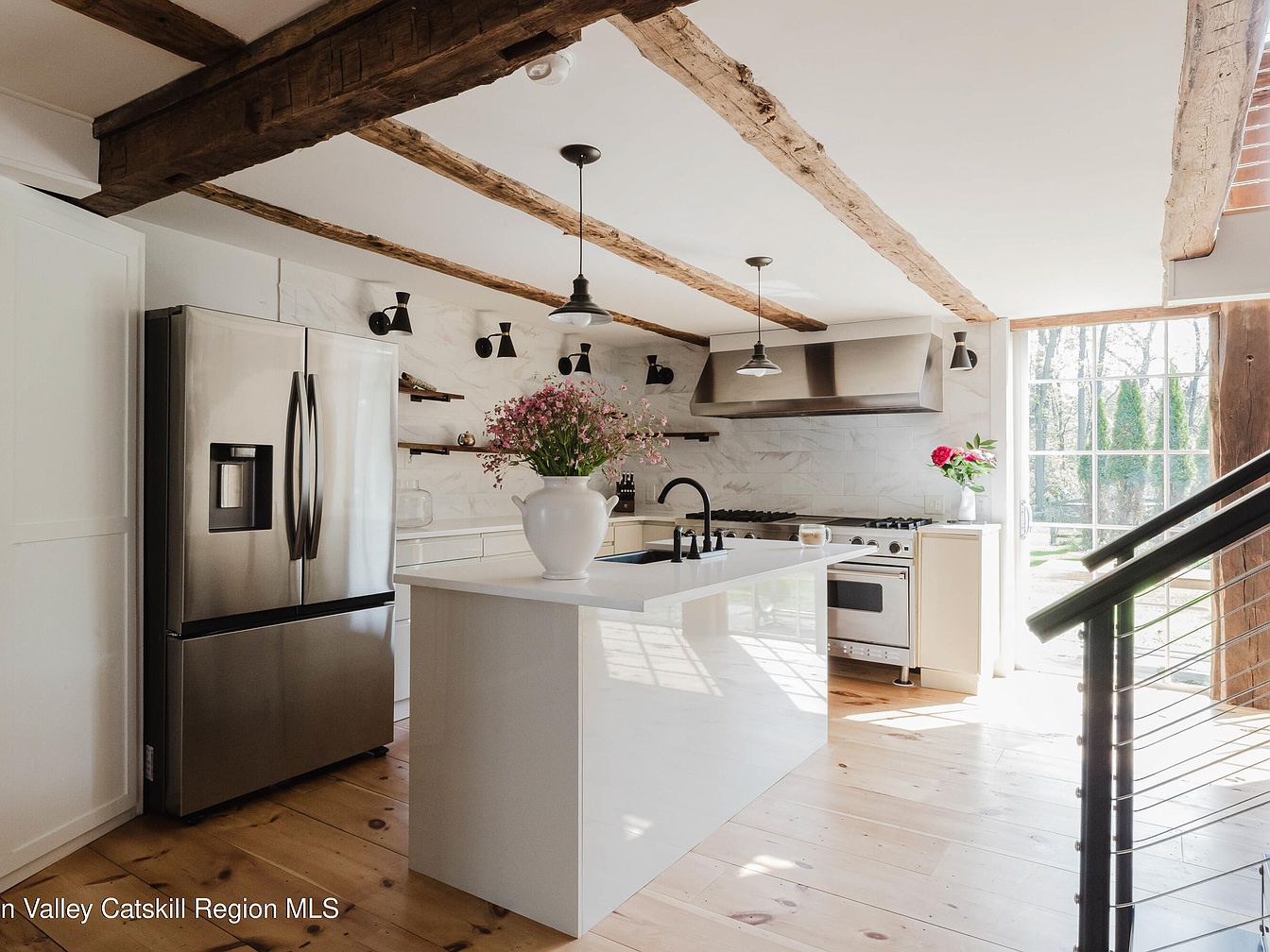 Modern kitchen with rustic wooden beams and a central island
