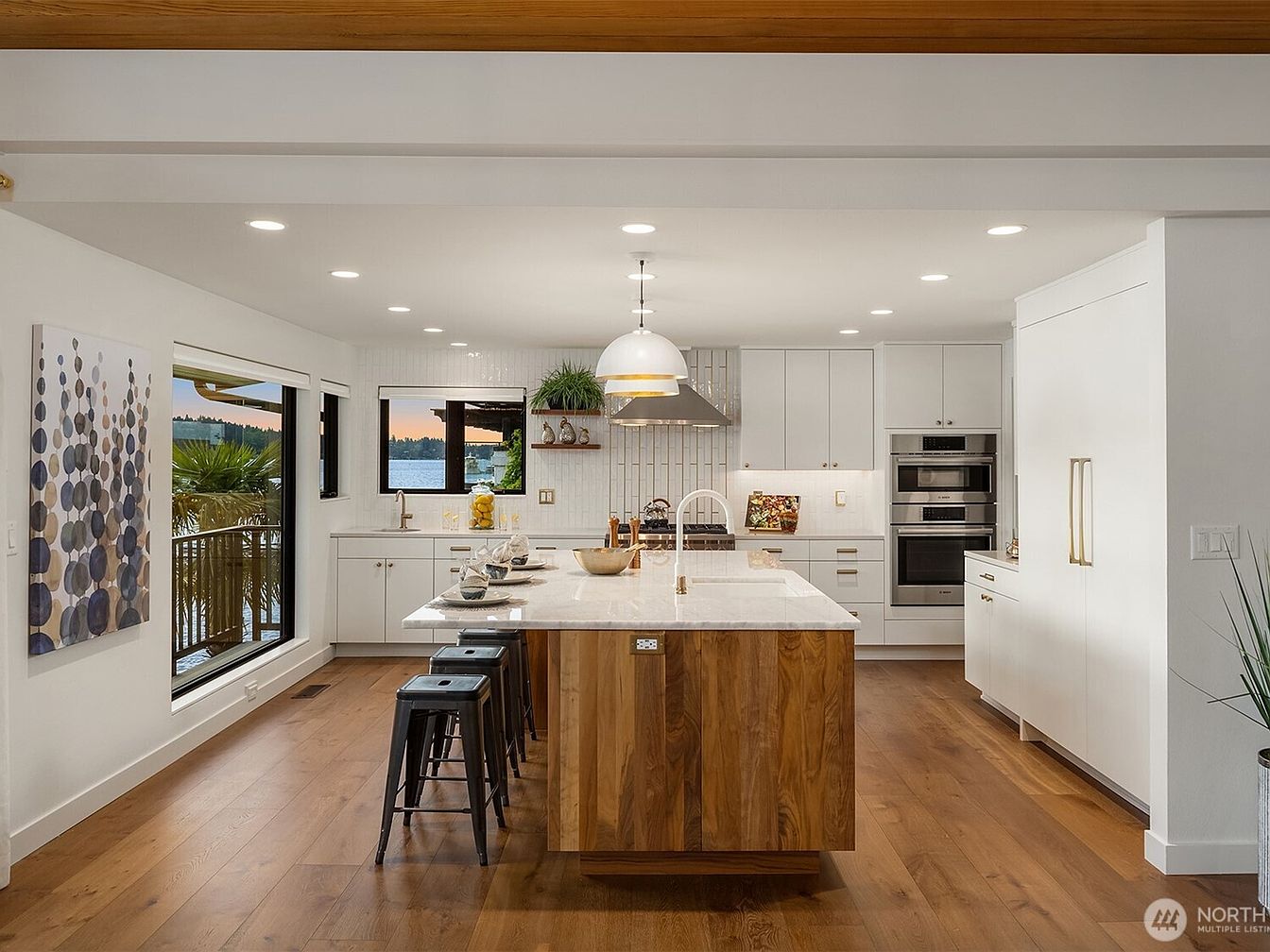 Modern kitchen with wooden island and white cabinetry