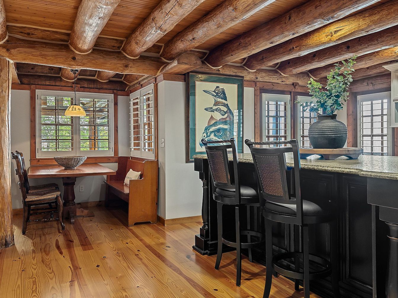 Rustic kitchen dining nook with wooden beams and breakfast bar seating