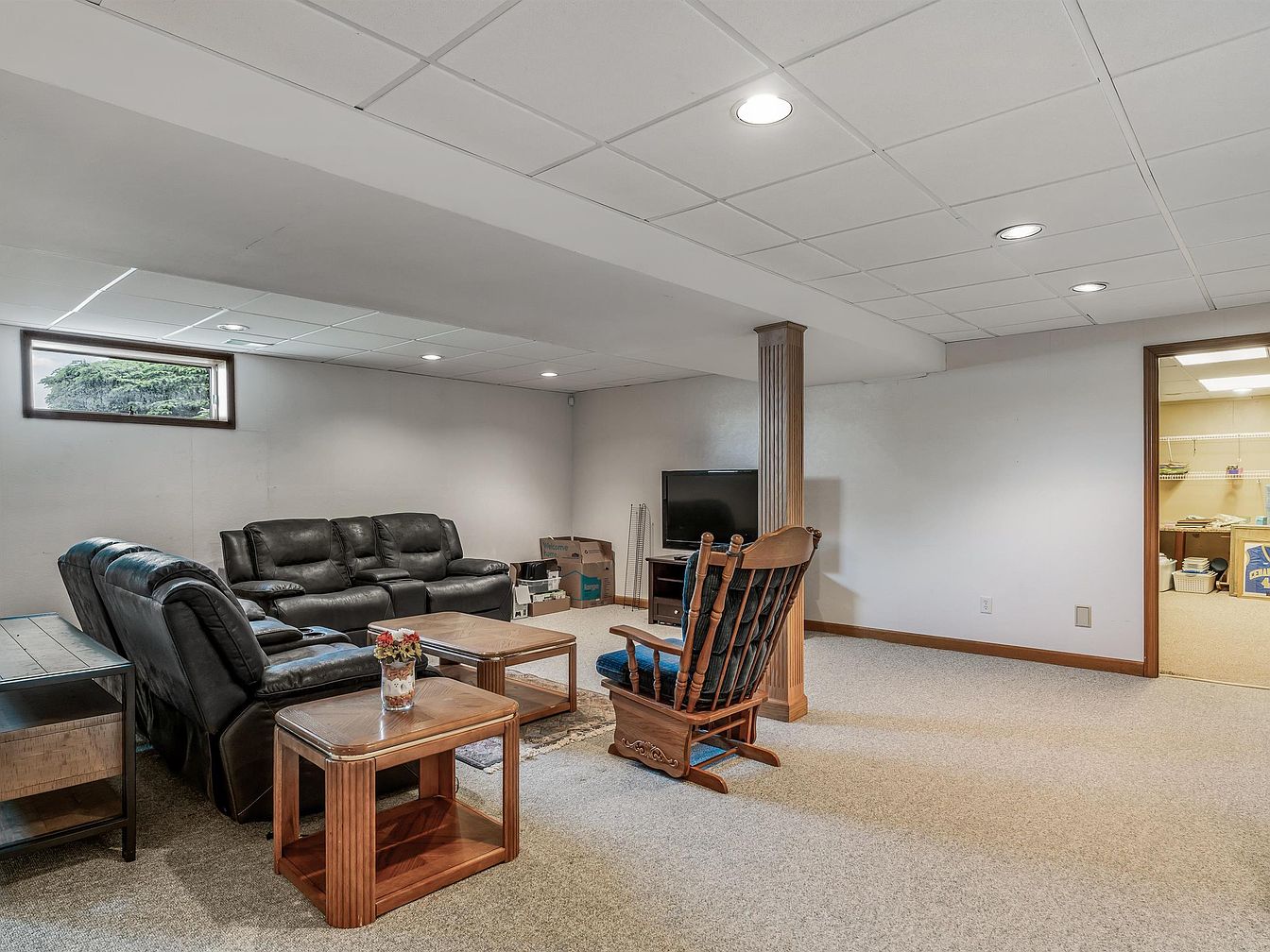 Basement lounge area with sectional sofa and rocking chair