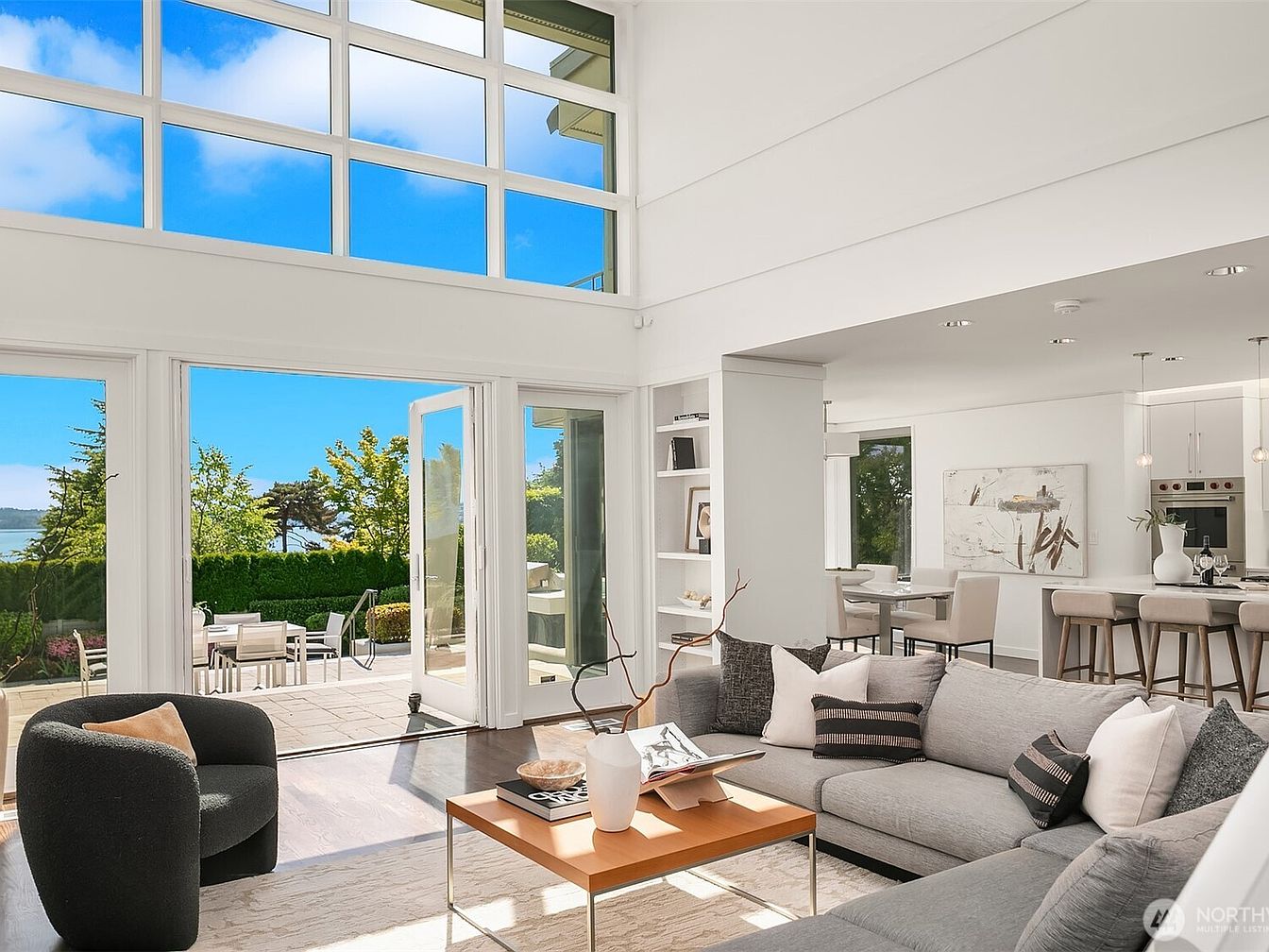 Bright living room with large windows and view to patio and outdoors