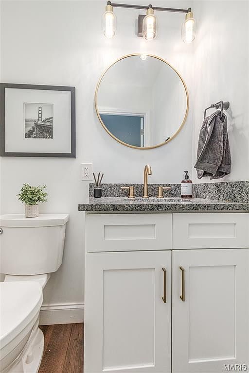 Bathroom vanity with round mirror and sink