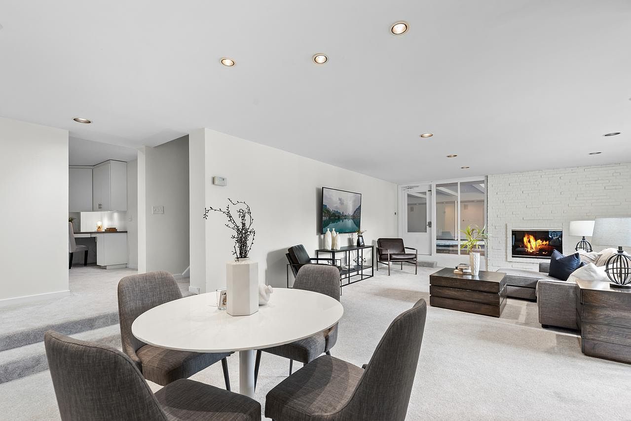 Spacious living and dining area with neutral tones and modern furnishings