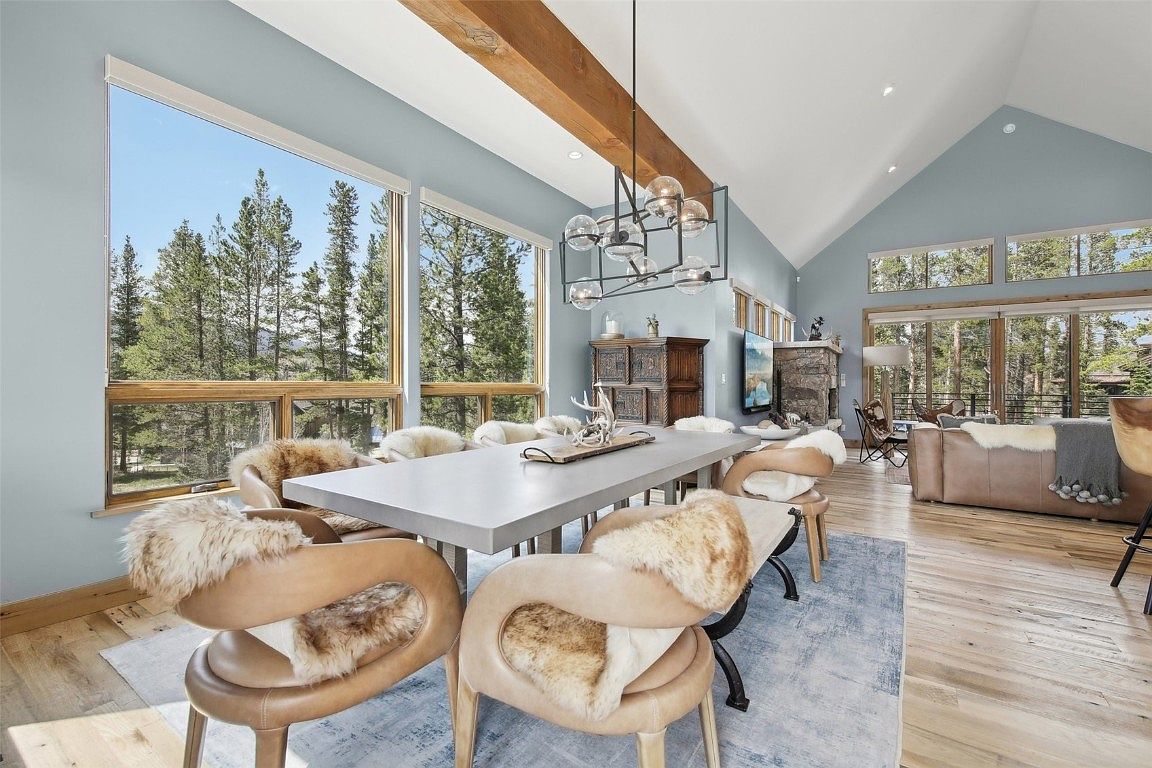Open dining and living space with large windows and modern furnishings